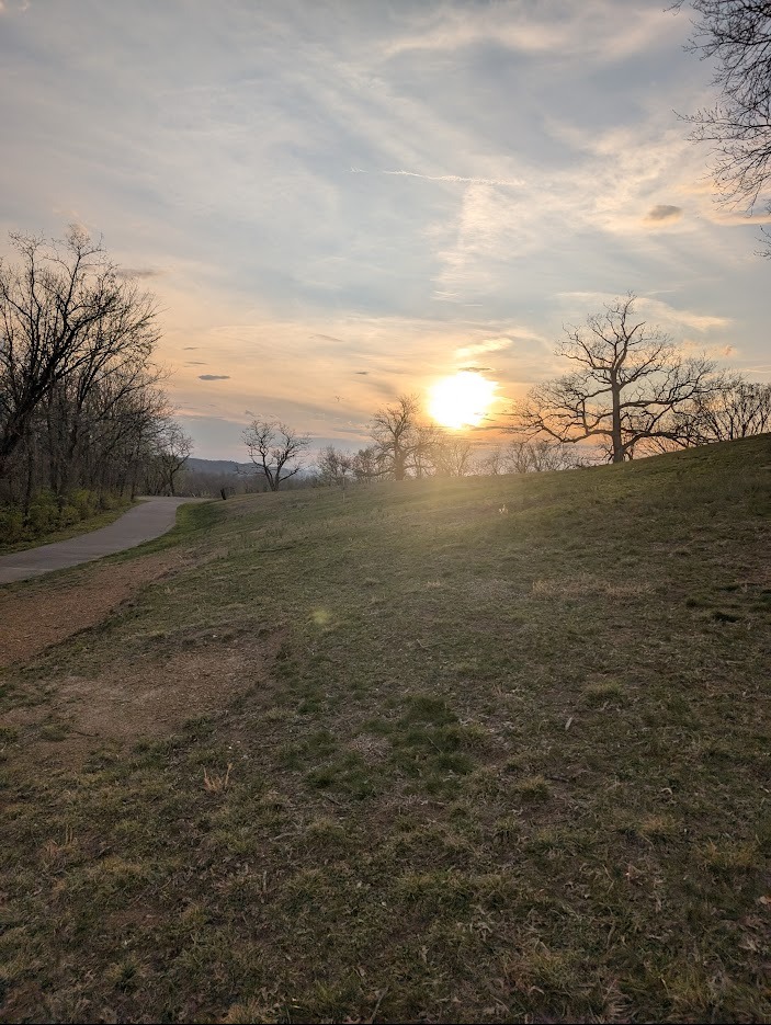 From about the middle of the ridge line.  The basket is just to the left of the sun.
