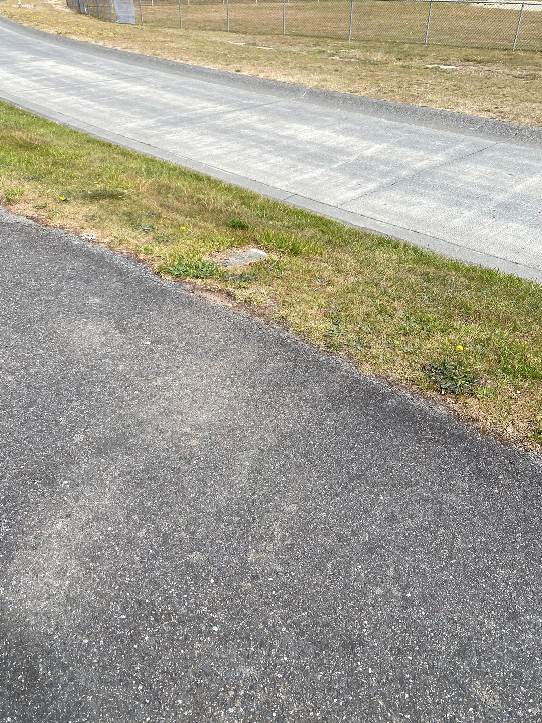 A water meter marks the corner of the 9A tee box on the walking path when facing the Gazebo.