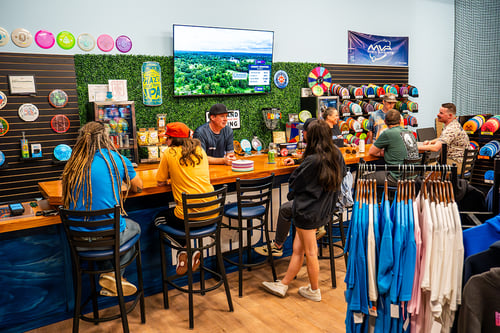 The Bar at Throw Coast is a great place to grab a drink, hang out, watch live disc golf, and share stories from the course!