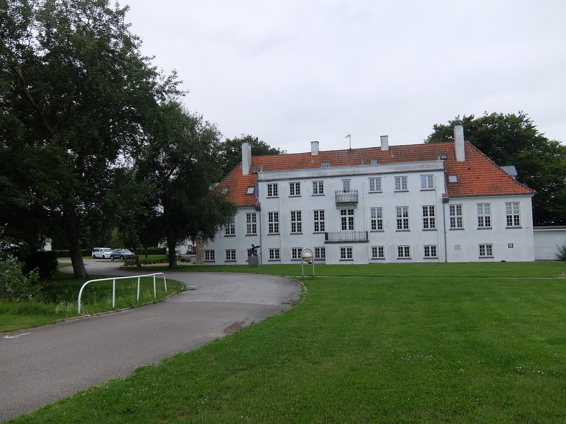 When you arrive from the main road, you will get to the beautiful entrance to Klintsøgård School, just follow the road left of this main building