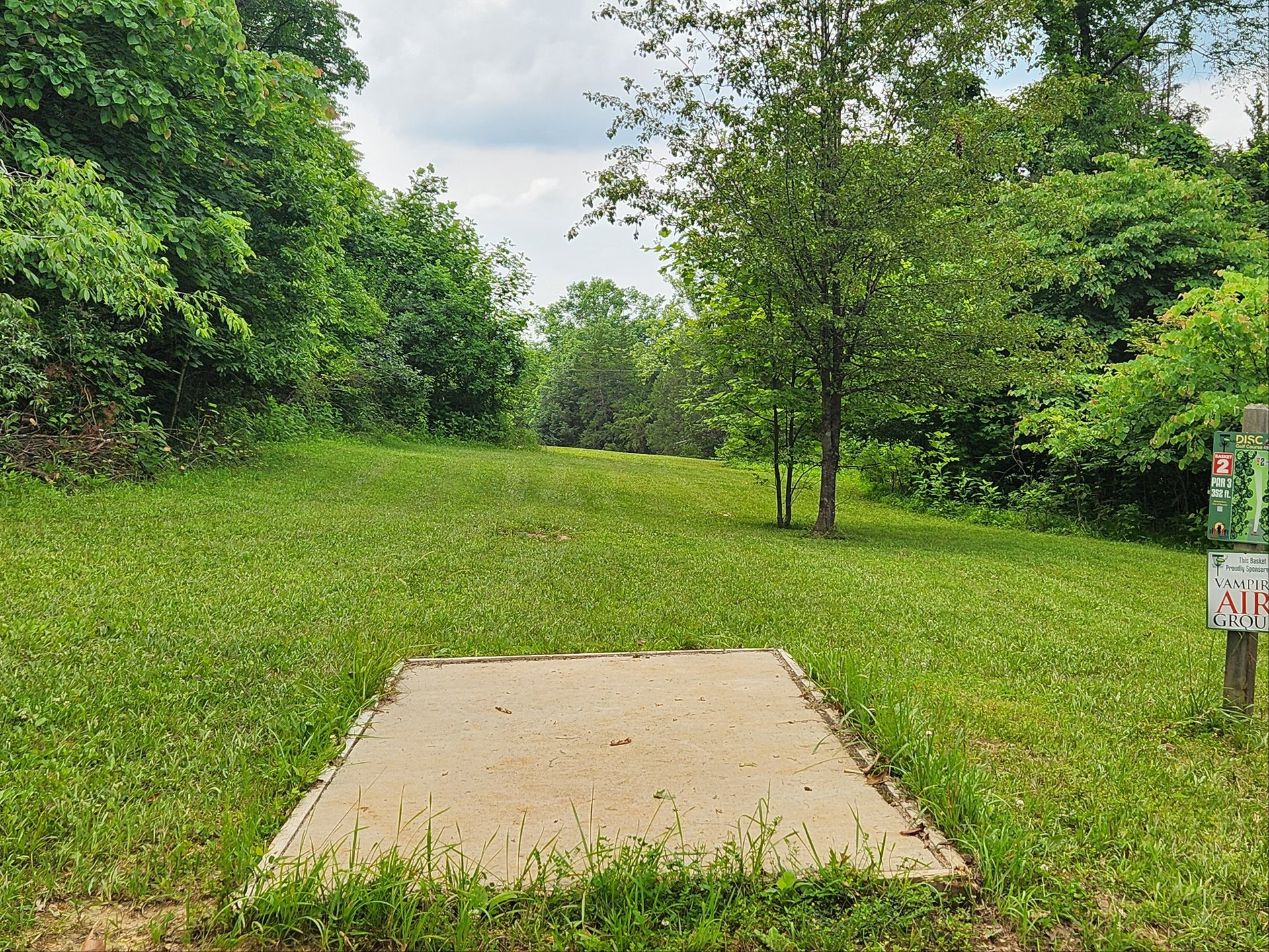 Hole 2 tee pad
basket located left side near road
