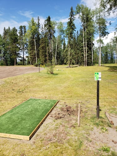 Parking lot to left is OB. Basket is nestled in trees .