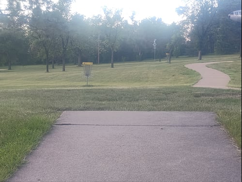 Hole 1 basket is the further of the two. Closer is a practice basket