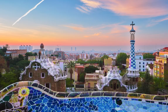 Barcelona city view from Guell Park. Sunrise view of colorful mosaic building in Park Guell