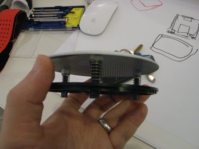Close-up of the underside of the Social Speaker prototype and its mechanical assembly.