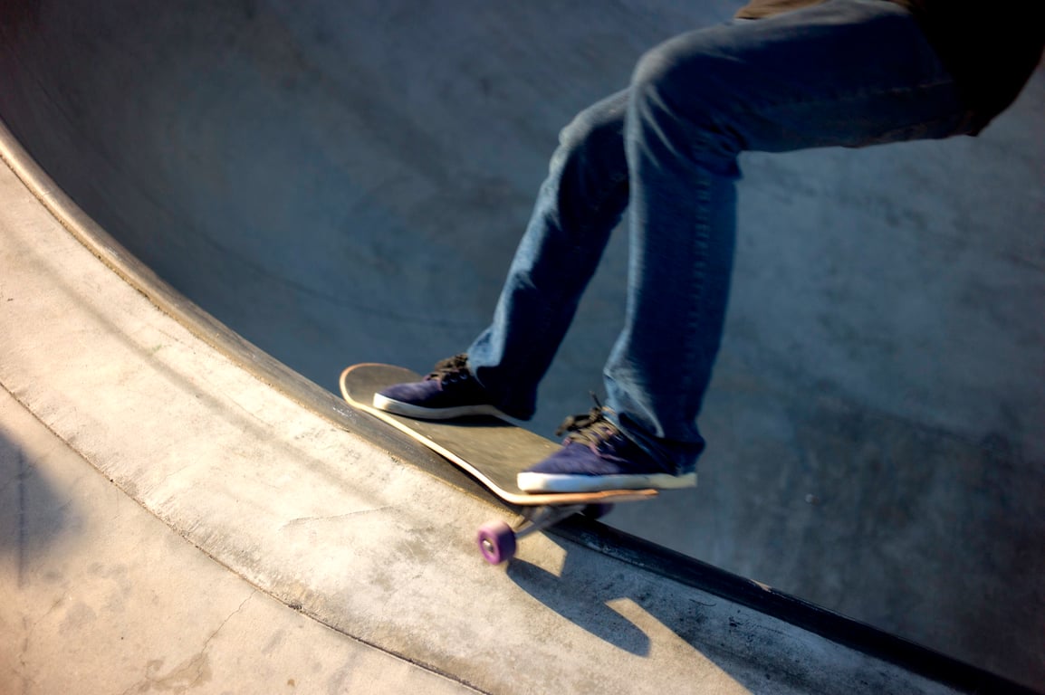 A skateboarder performing a Smith grind.