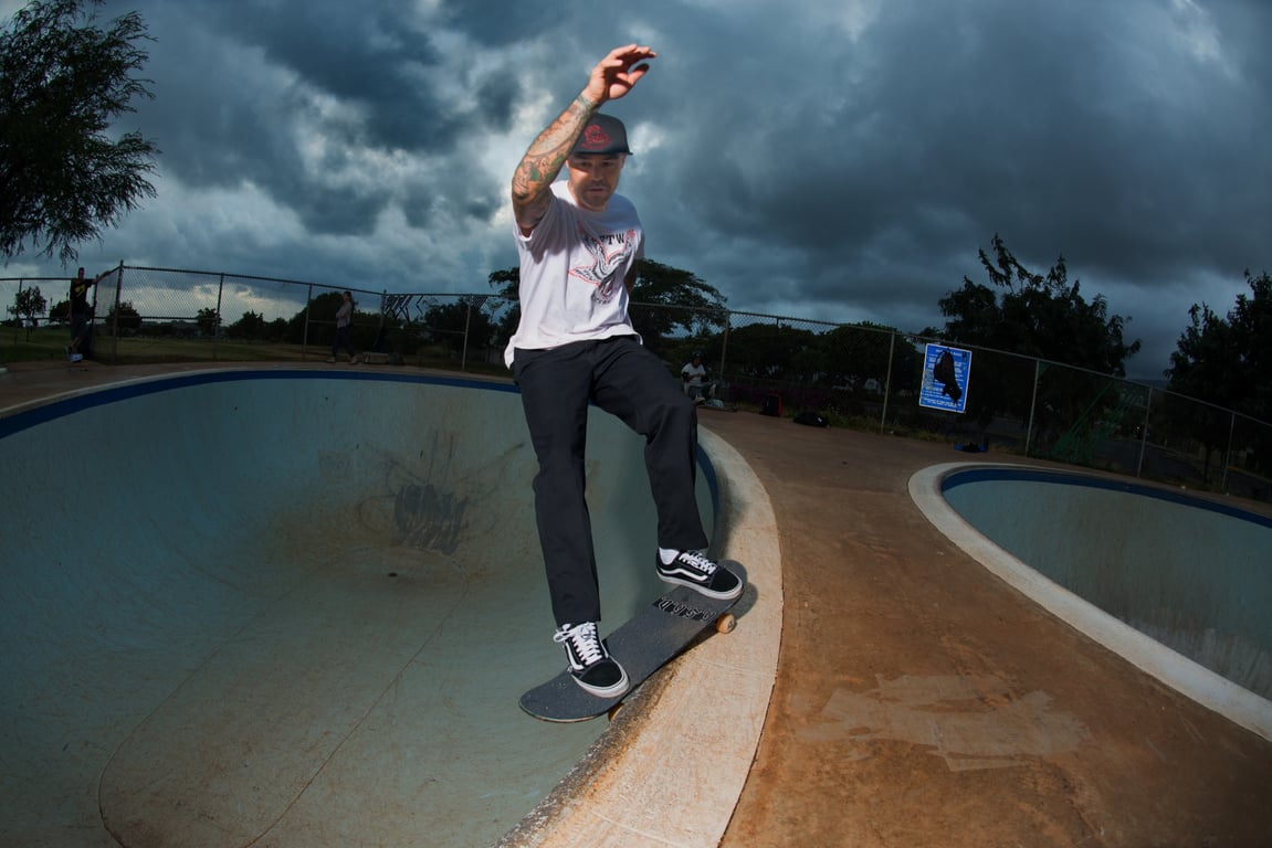 A skateboarder performing a Smith grind.