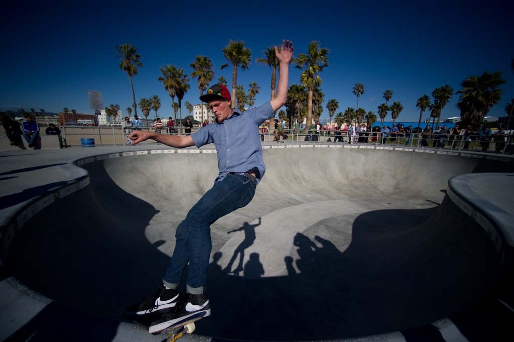 A skateboarder performing a Smith grind.