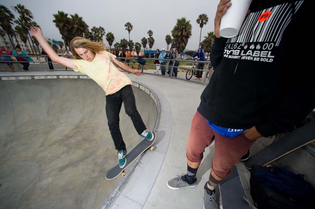 A skateboarder performing a Smith grind.