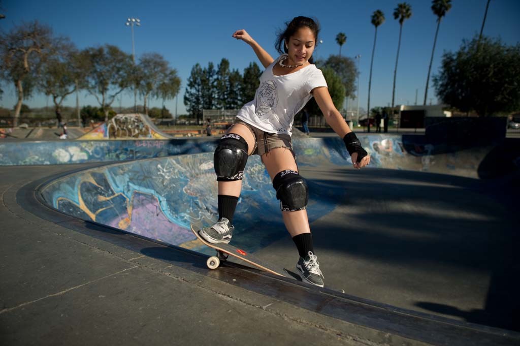 A skateboarder performing a Smith grind.