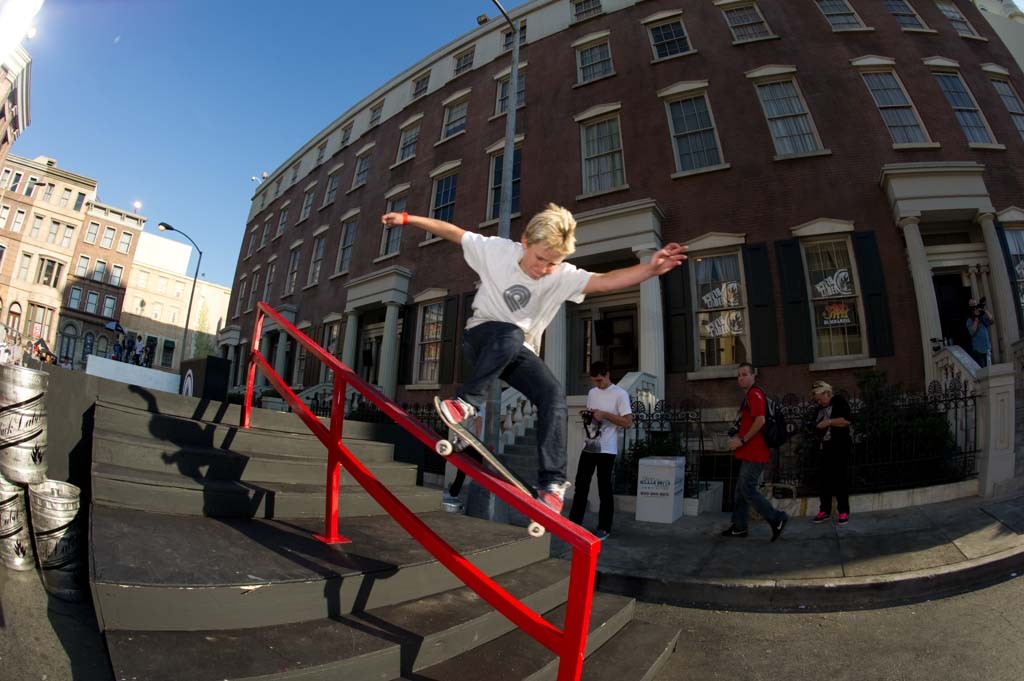 A skateboarder performing a Smith grind.