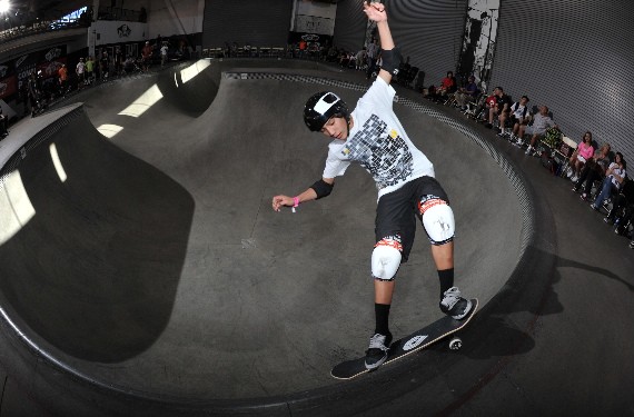 A skateboarder performing a Smith grind.