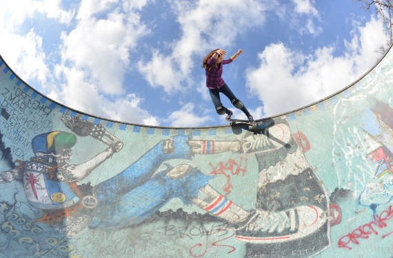 A skateboarder performing a Smith grind.