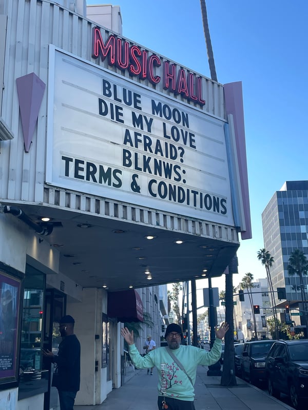 Me standing under the movie marquee for BLKNWS Terms & Conditions at the Lumiere Theater in Beverly Hills