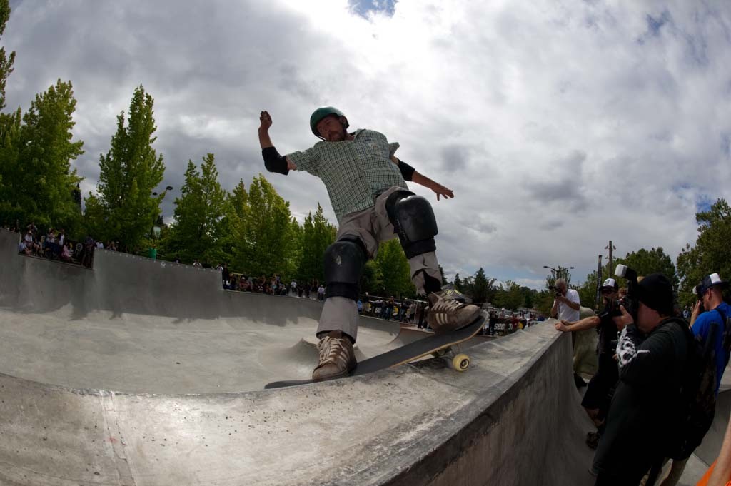 A skateboarder performing a Smith grind.
