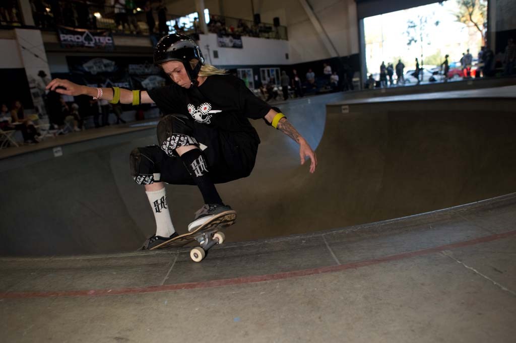 A skateboarder performing a Smith grind.
