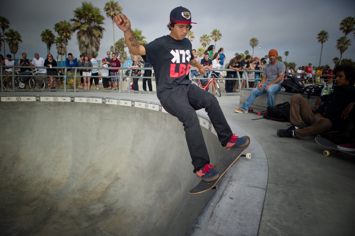 A skateboarder performing a Smith grind.