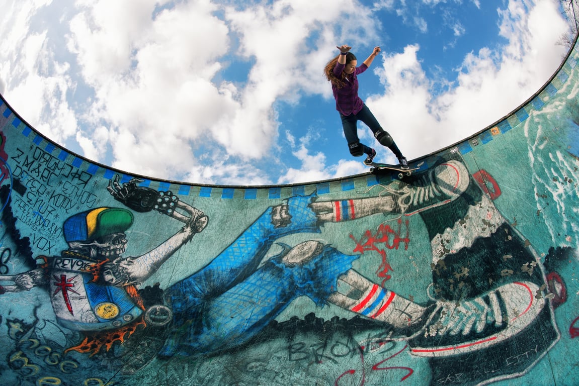 A skateboarder performing a Smith grind.