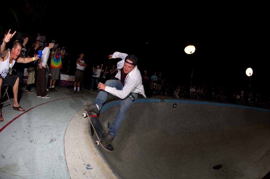 A skateboarder performing a Smith grind.
