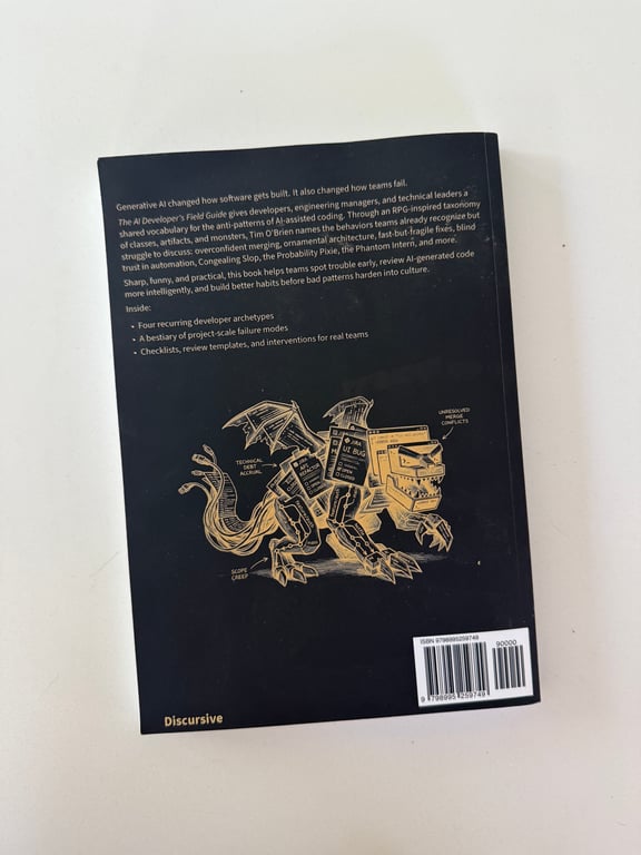 Full photograph of the black back cover of The AI Developer's Field Guide, Volume I by Tim O'Brien, with a summary, mechanical dragon illustration, and ISBN barcode.