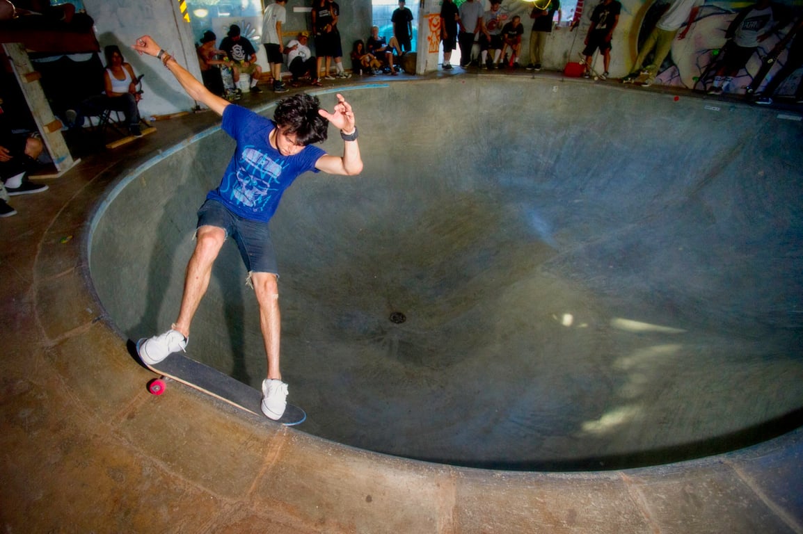 A skateboarder performing a Smith grind.