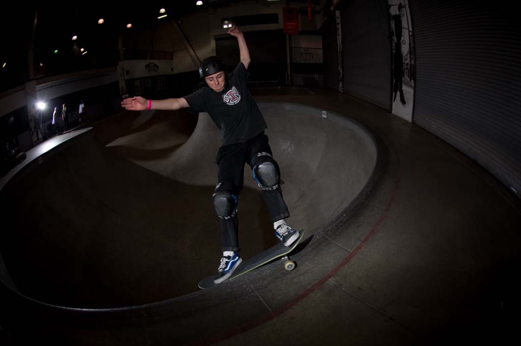 A skateboarder performing a Smith grind.