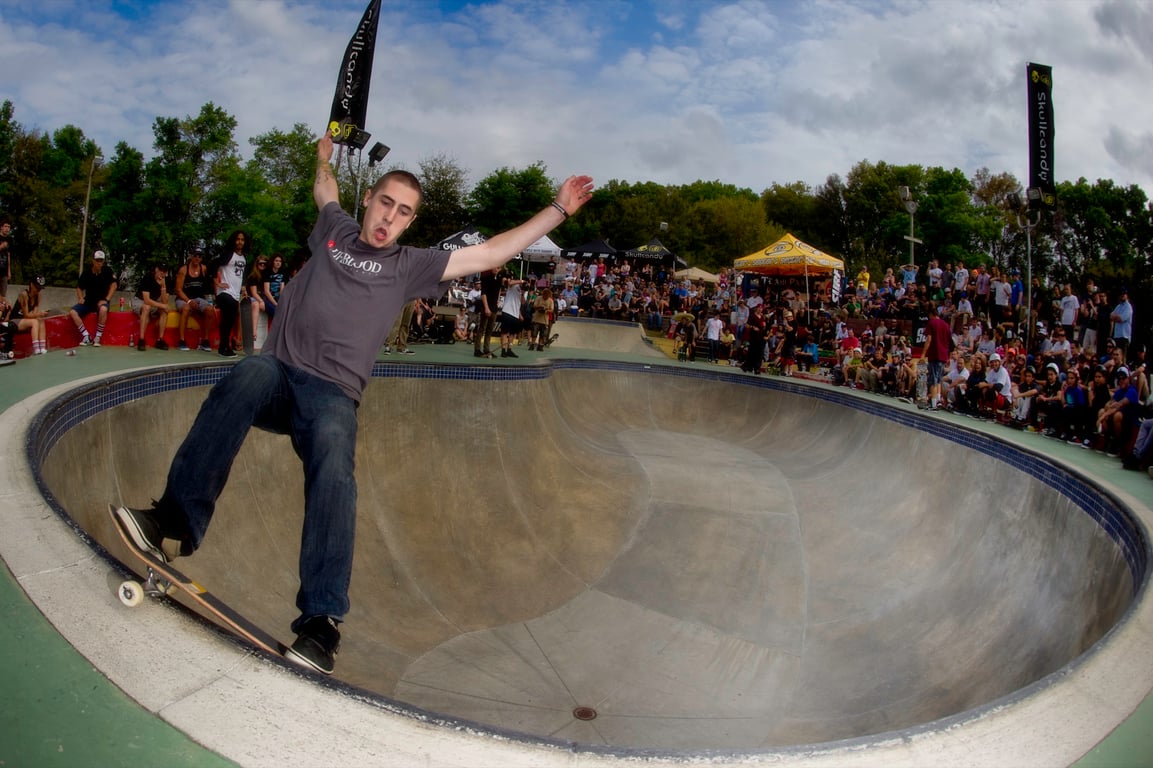 A skateboarder performing a Smith grind.