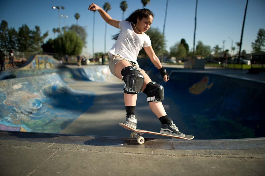 A skateboarder performing a Smith grind.
