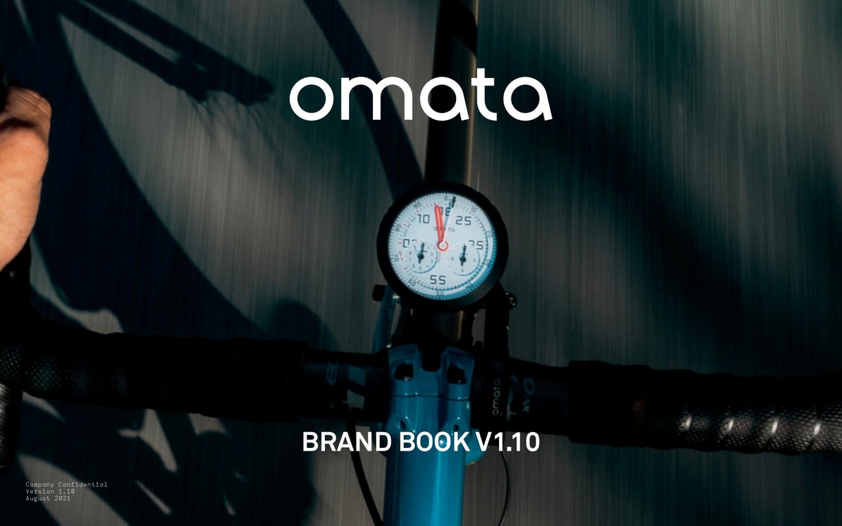 OMATA Brand Book v1.10 cover: white wordmark above a round instrument mounted on blue bicycle handlebars.