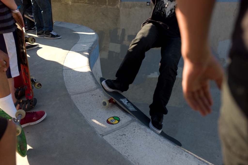 A skateboarder performing a Smith grind.