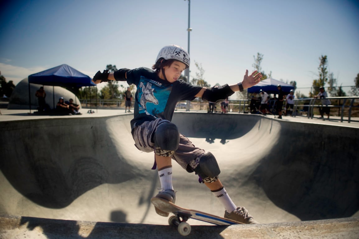 A skateboarder performing a Smith grind.