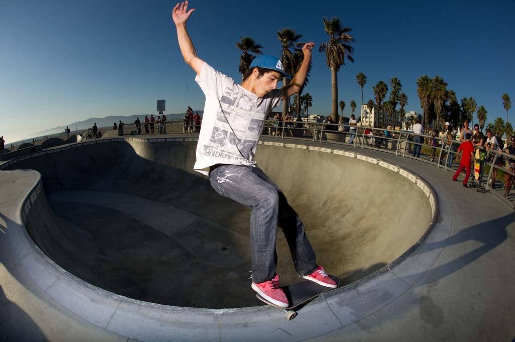 A skateboarder performing a Smith grind.