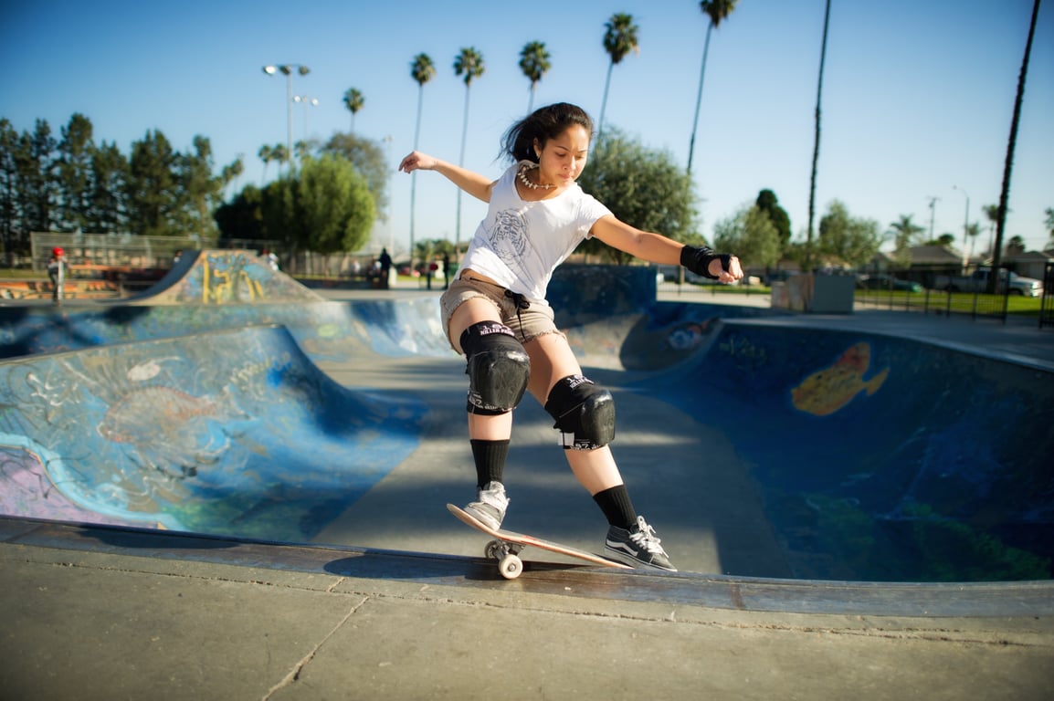 A skateboarder performing a Smith grind.