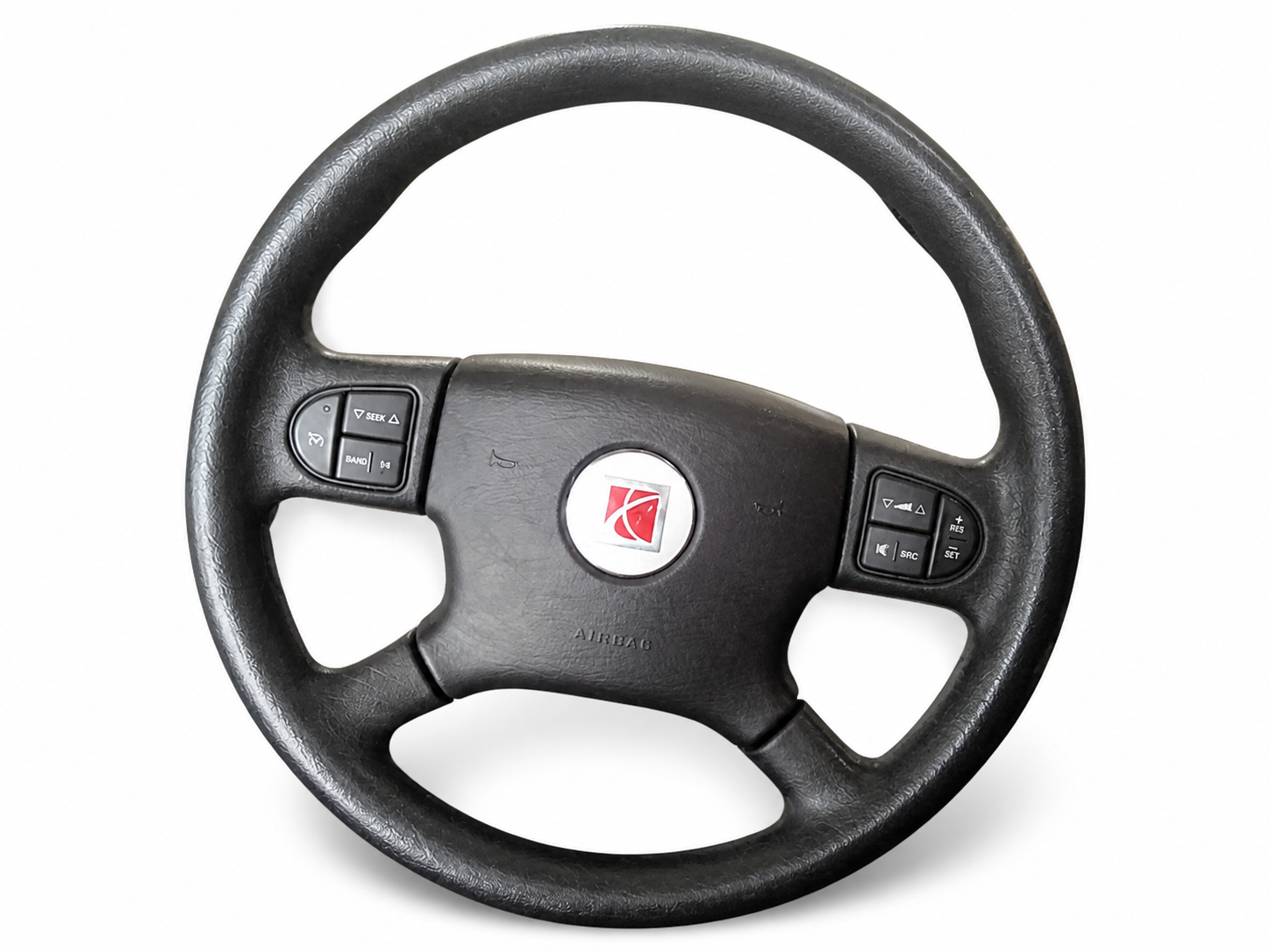 A Saturn Ion steering wheel with a black rim and center emblem.