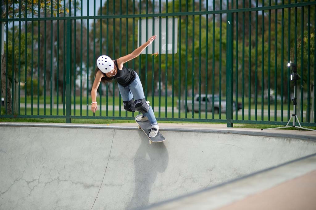 A skateboarder performing a Smith grind.