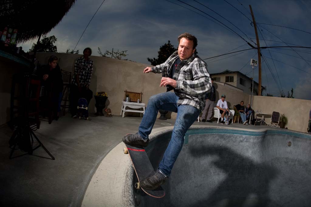 A skateboarder performing a Smith grind.