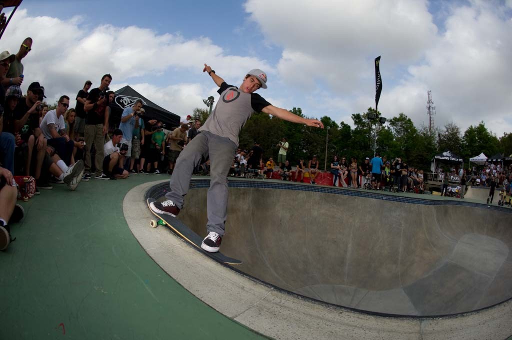 A skateboarder performing a Smith grind.