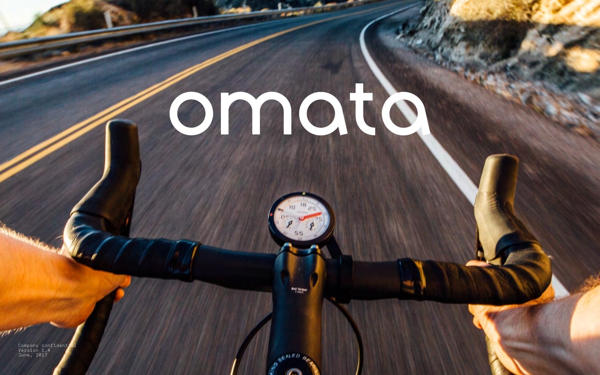 OMATA Brand Book v1.4 cover: a view over handlebars and the round instrument on a curving road.
