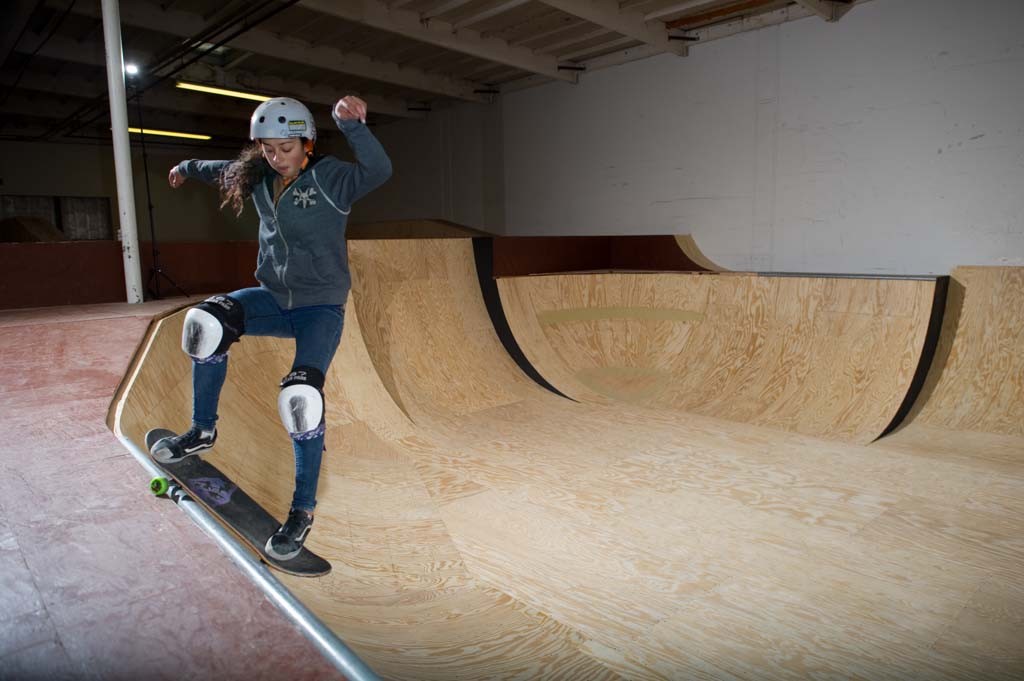 A skateboarder performing a Smith grind.