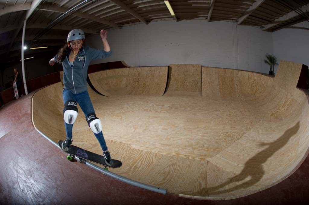 A skateboarder performing a Smith grind.