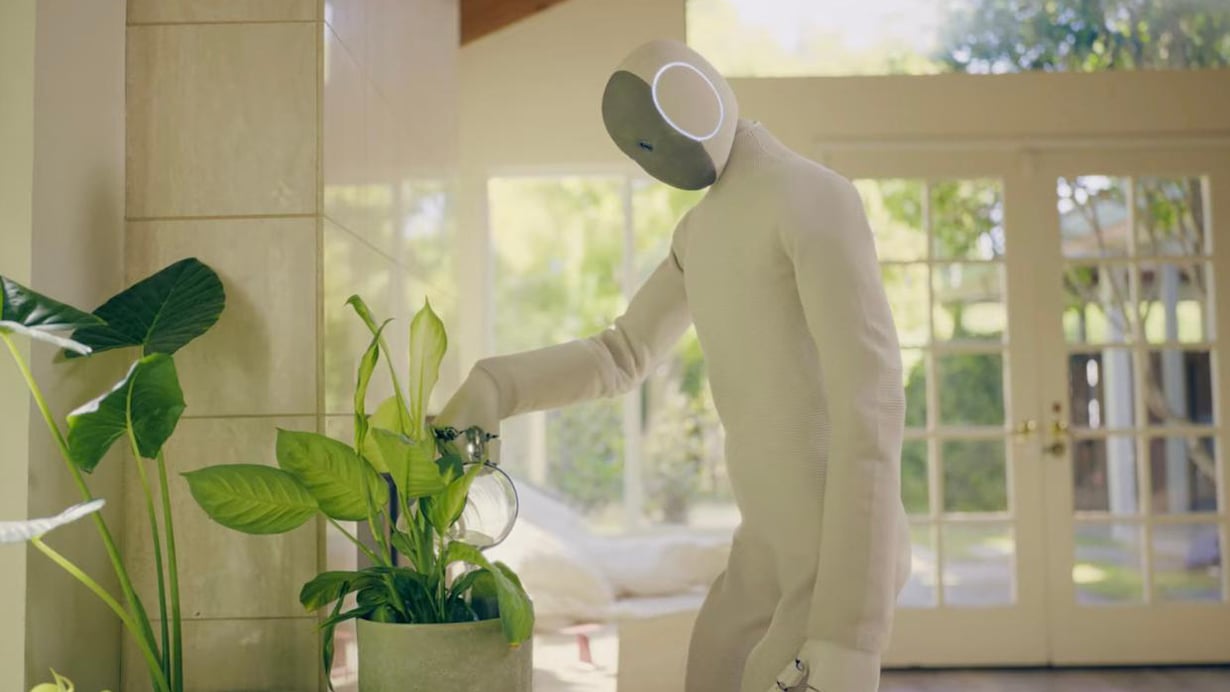 A Neo Home Helper robot watering some domestic plants.