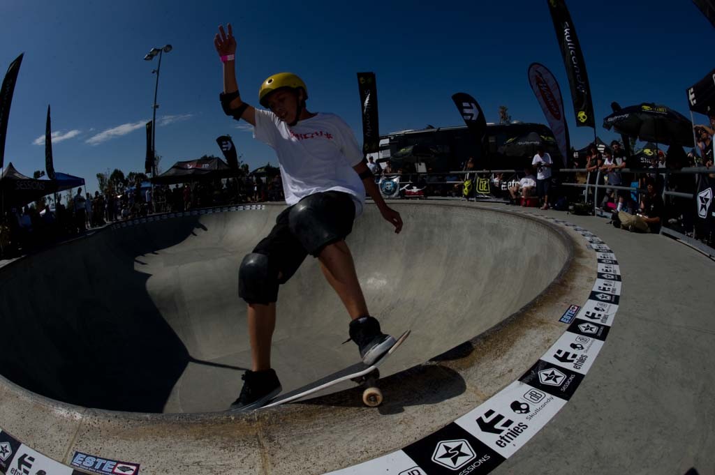 A skateboarder performing a Smith grind.