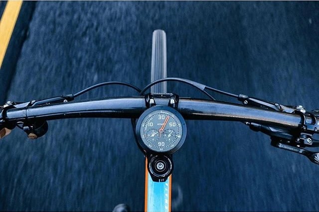 View from bicycle handlebars with an Omata cycling computer mounted at the centre.