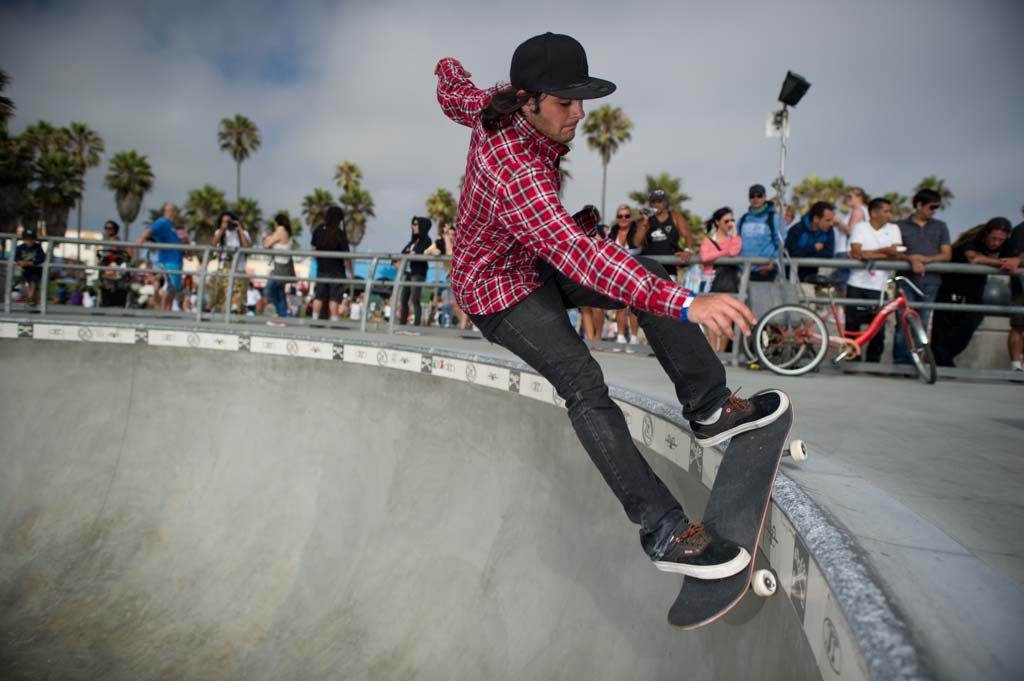A skateboarder performing a Smith grind.