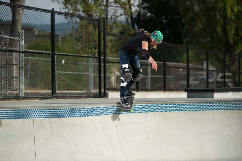 A skateboarder performing a Smith grind.