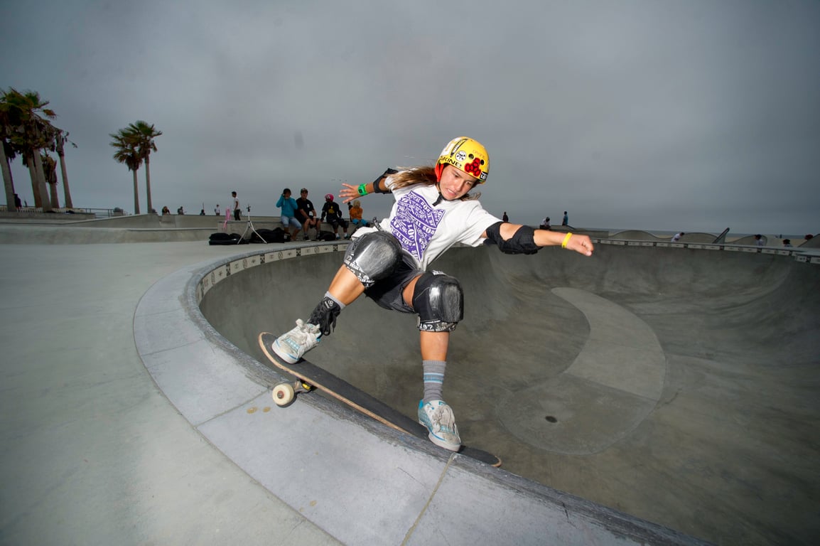A skateboarder performing a Smith grind.