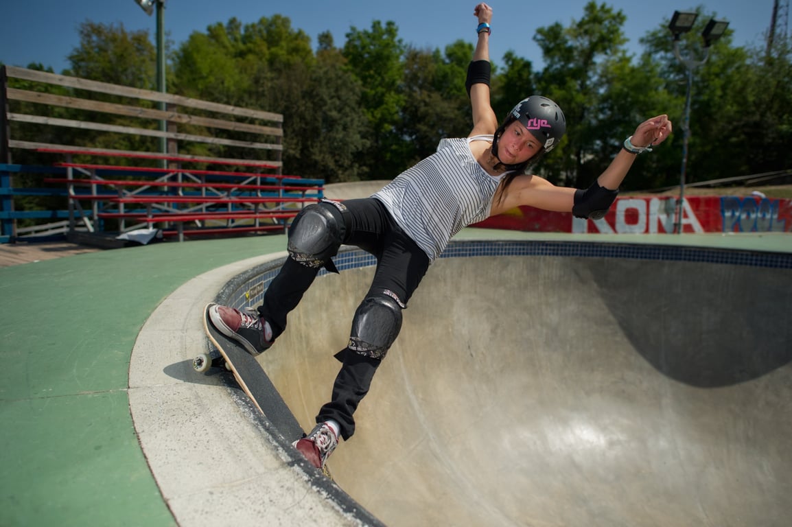 A skateboarder performing a Smith grind.