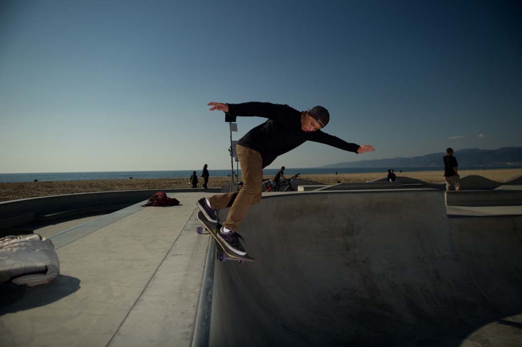 A skateboarder performing a Smith grind.