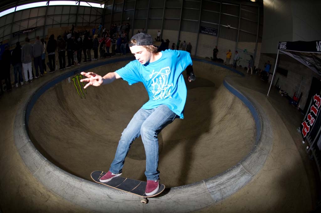 A skateboarder performing a Smith grind.