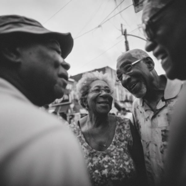 A group of long-lived people enjoying a street fair in Fort Greene